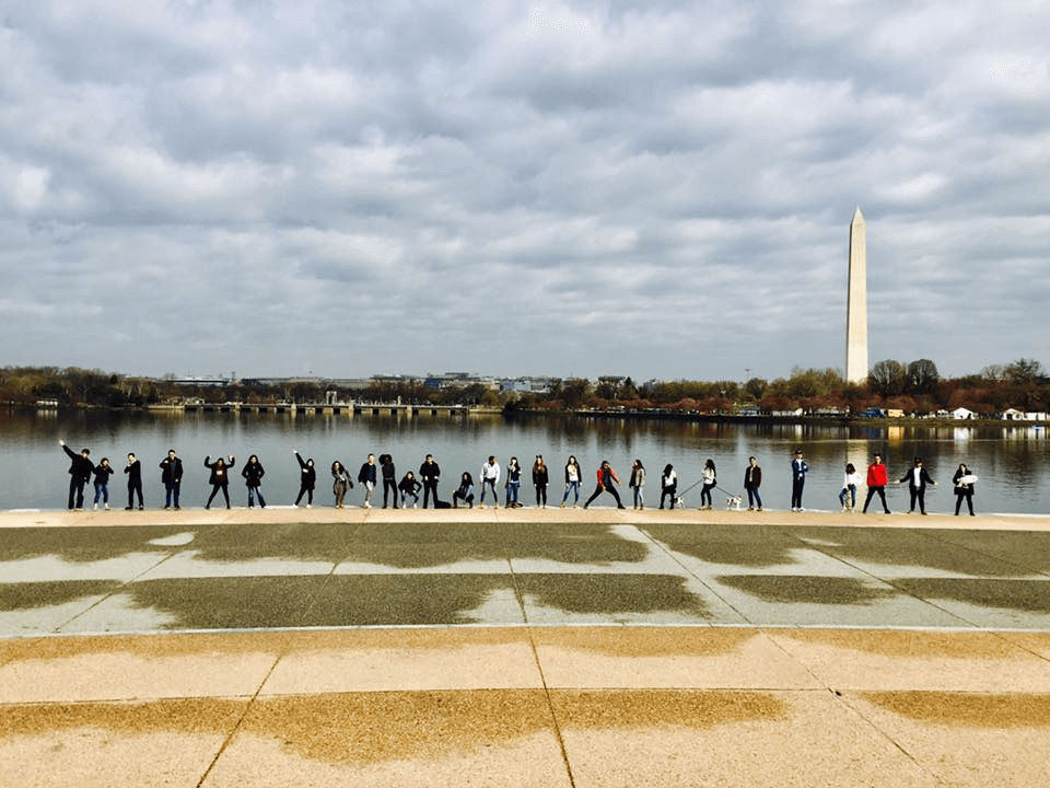 Photo of students with the tidal basin and Washington monument behind them
